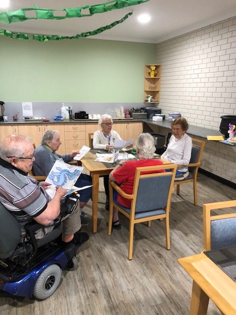 Residents at Mercy Care reading the letters