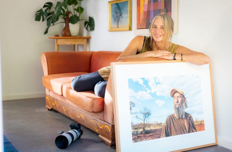 Nic Duncan with her photo of gold prospector Johnny Day, which was a finalist in the National Portrait Prize. © Serena Kirby