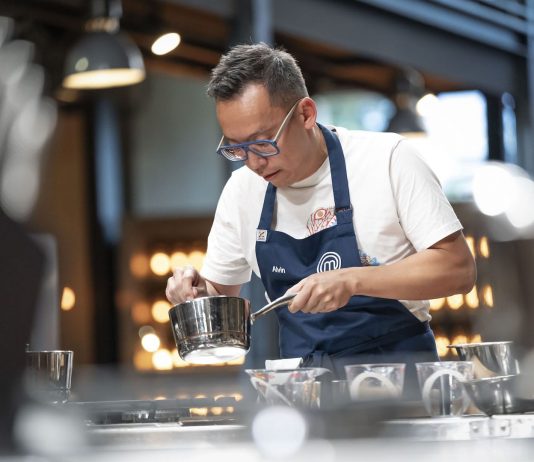 Alvin Quah deep in focus cooking on masterchef