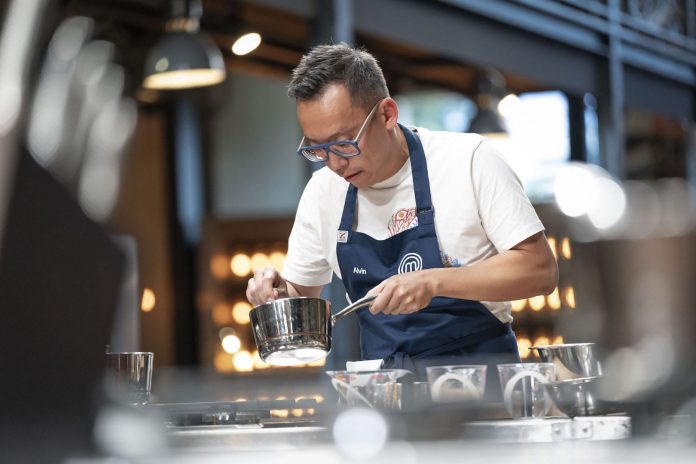 Alvin Quah deep in focus cooking on masterchef